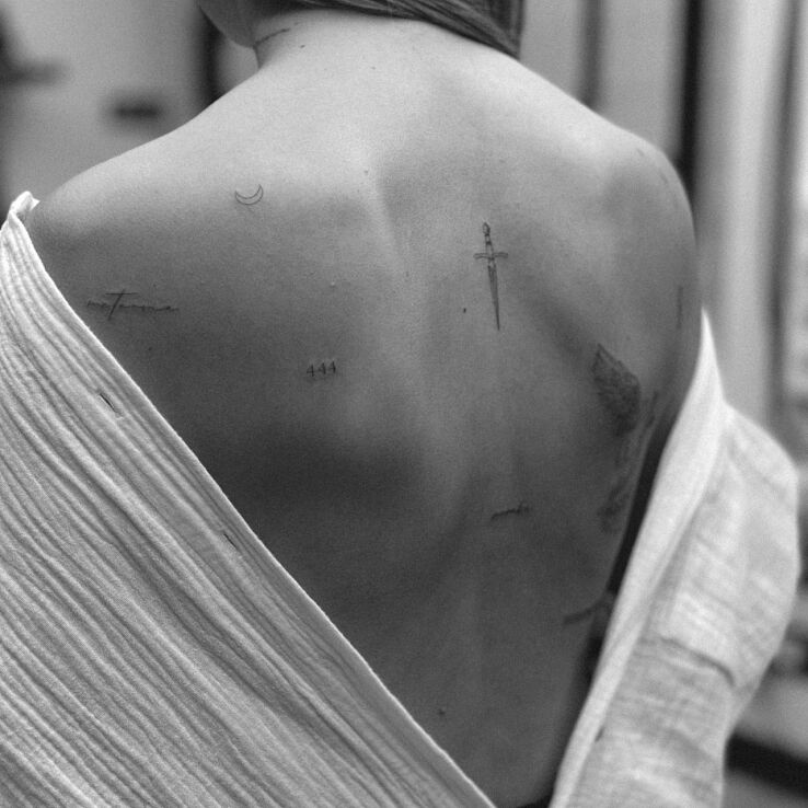 Tattoo A few small additions in lettering motif and minimalistic style on the back
