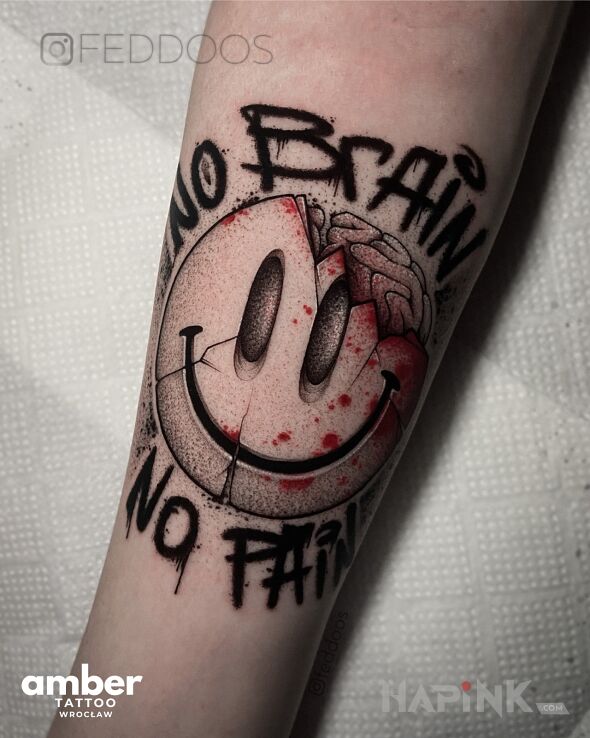Tattoo Uśmiechnięte emoi in black and gray motif and graffiti style On the arm