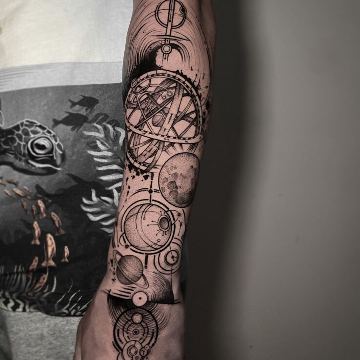 Tattoo Planetary system in black and gray motif and graphic / illustrative style On the arm