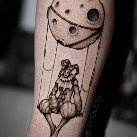 Tattoo Jester on the calf motif: black and gray style: graphic / illustrative