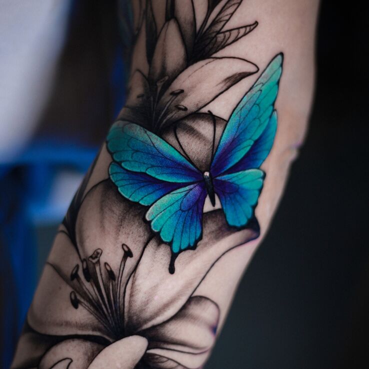 Tattoo Blue Butterfly in butterflies motif and realistic style On the arm