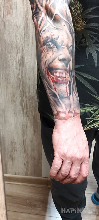 Tattoo Zakrwawiony maniak in demons motif and realistic style on the forearm