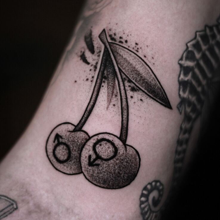 Tattoo Cherry mini tattoo in black and gray motif and graphic / illustrative style on the bicep