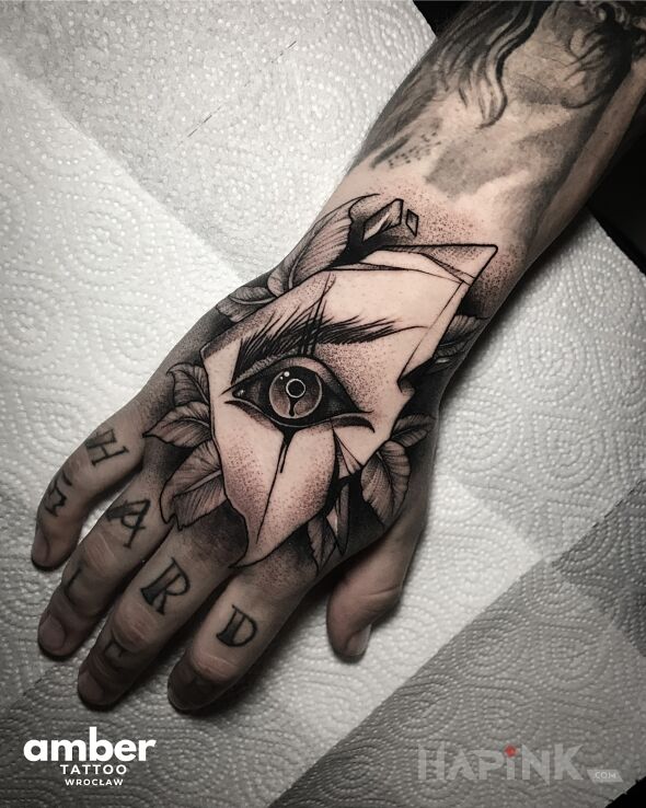 Tattoo Oko z liśćmi róży in black and gray motif and dotwork style On the arm