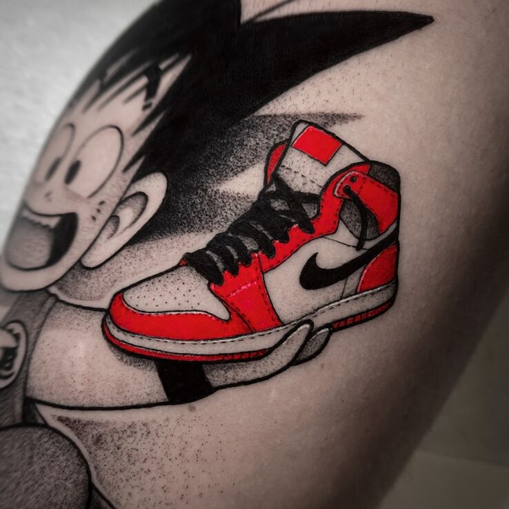 Tattoo Colorful Nike sneakers in characters motif and dotwork style on the calf