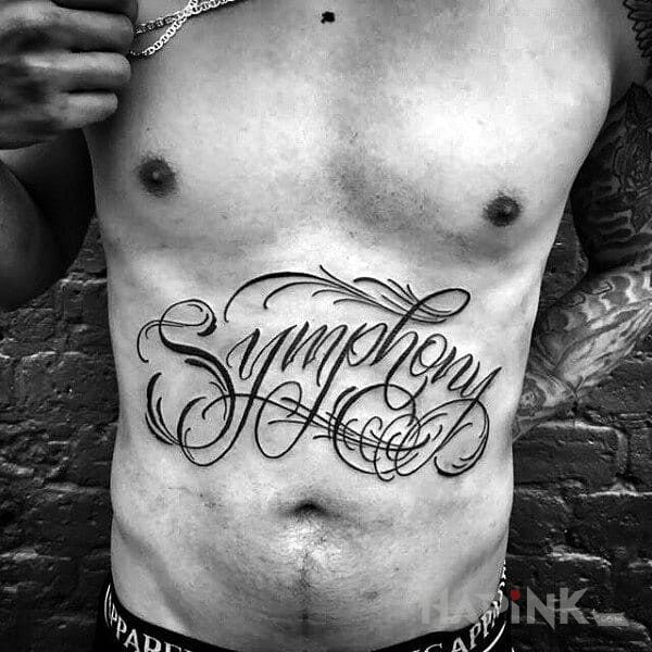 Tattoo Symphony in lettering motif on the stomach