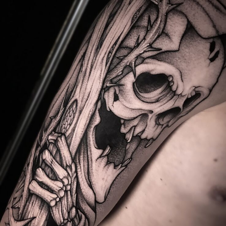 Tattoo Image of Death in skulls motif and graphic / illustrative style On the arm