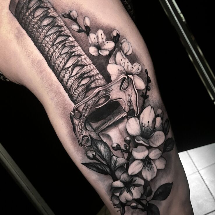 Tattoo Katana in flowers in objects motif and realistic style on the thigh