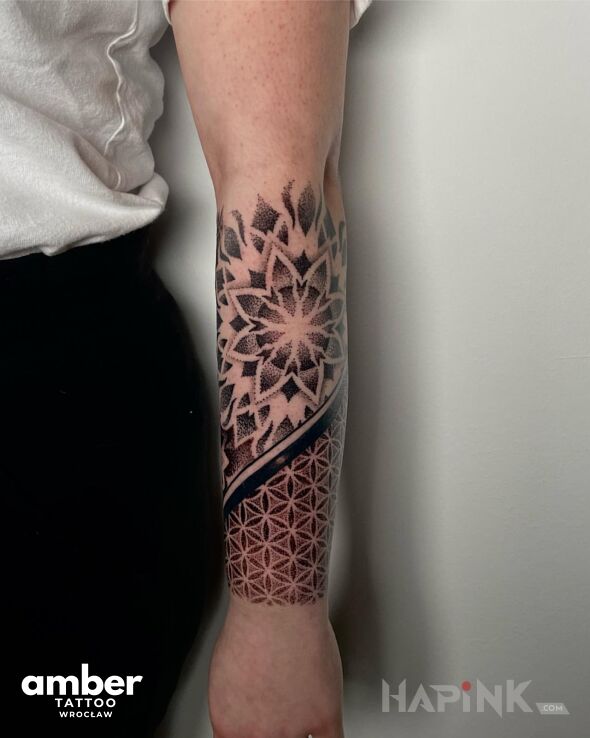 Tattoo Mandala in black and gray motif and geometric style On the arm