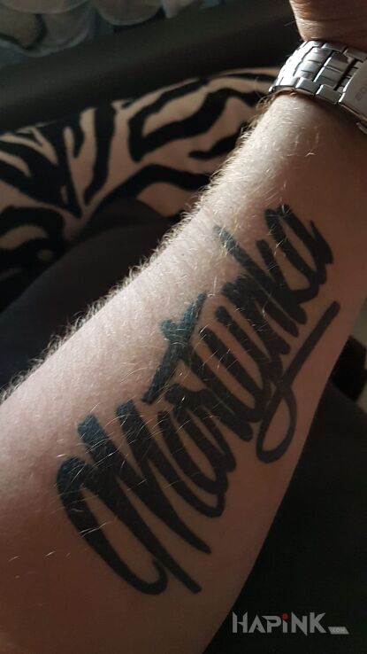 Tattoo Napis in lettering motif on the forearm