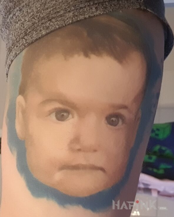 Tattoo Portret syna in faces motif and realistic style On the arm