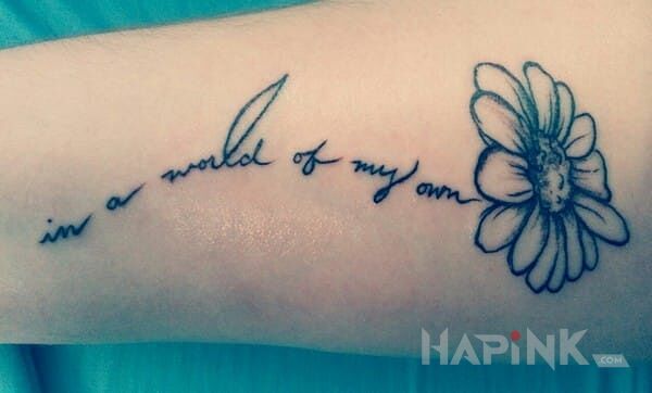 Tattoo Napis z kwiatem in lettering motif on the forearm