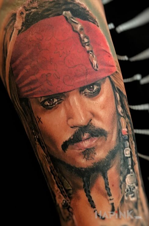 Tattoo Jack Sparrow portret. in colorful motif and realistic style On the arm