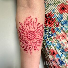 Tattoo Red flower on the forearm motif: flowers style: graphic / illustrative
