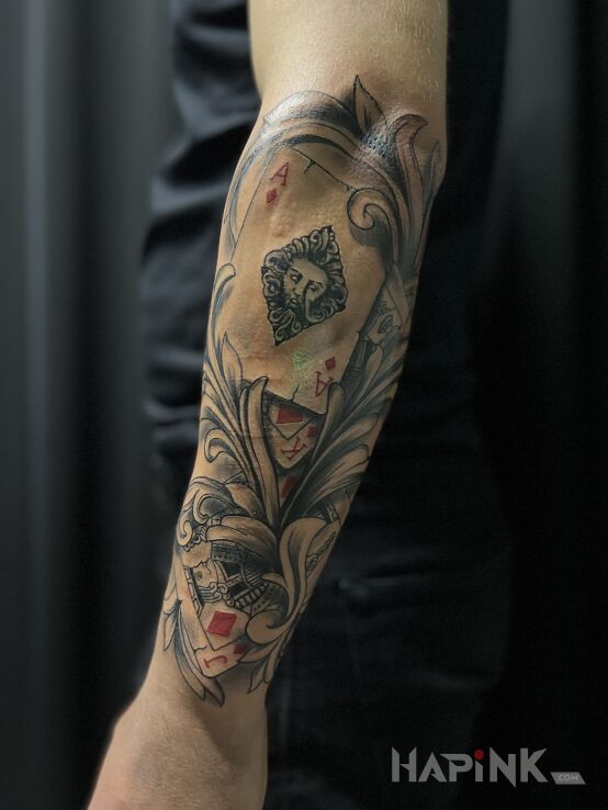Tattoo Tatuaż Karty in other motif and realistic style On the arm