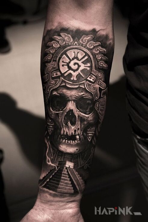Tattoo Aztek in skulls motif and realistic style on the forearm