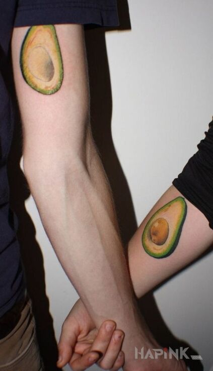 Tattoo Awokado in Love motif and realistic style on the upper arm