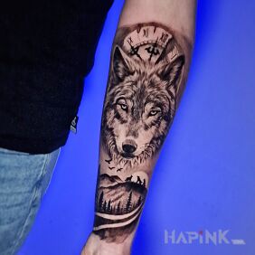 Tattoo Wolf and clock On the arm motif: black and gray style: realistic