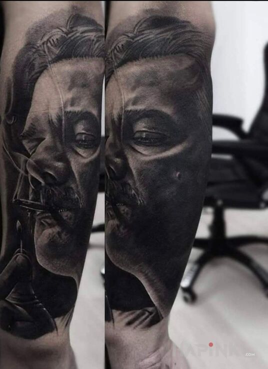 Tattoo Pablo Escobar in black and gray motif and realistic style On the arm