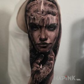 Tattoo Woman of wax on the upper arm motif: faces style: realistic