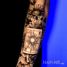 Tattoo Playing card and flowers on the forearm motif: black and gray style: realistic
