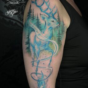 Tattoo Colorful deer tattoo on the upper arm motif: animals style: graphic / illustrative
