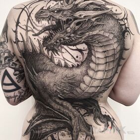 Tattoo Mega dragon on the shoulder blades motif: black and gray style: graphic / illustrative