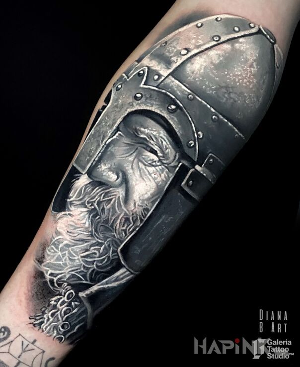 Tattoo Wiking in faces motif and realistic style on the forearm