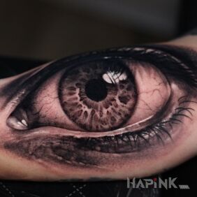 Tattoo Realistic eye On the arm motif: black and gray style: realistic