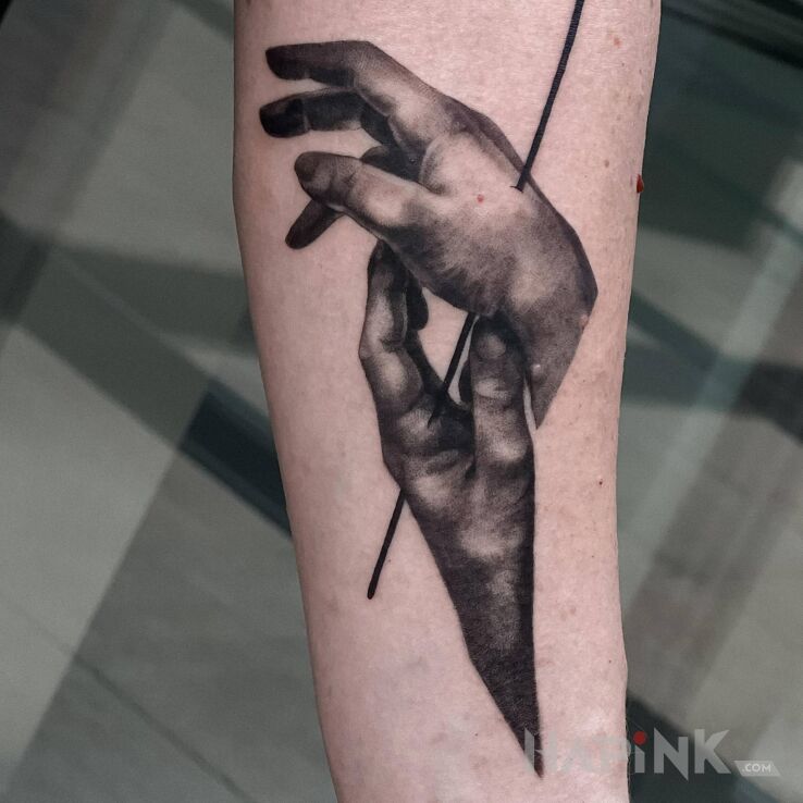 Tattoo Dłonie in black and gray motif and realistic style on the forearm