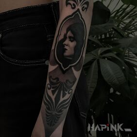 Tattoo Ornament with a female portrait inside on the wrist motif: faces style: realistic