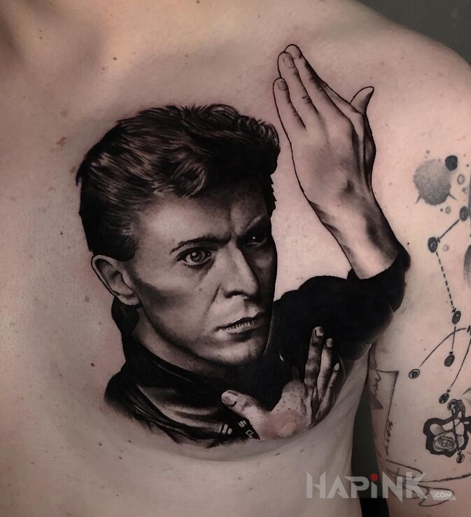 Tattoo David Bowe in characters motif and realistic style on the chest