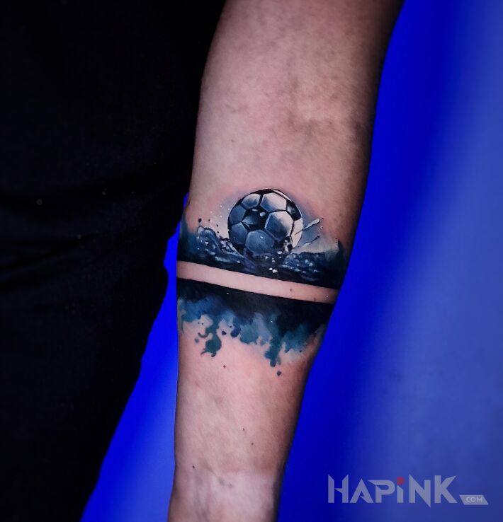 Tattoo Bransoletka akwarela z piłką nożną in colorful motif and abstract style on the forearm