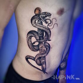 Tattoo Snake with a dagger on the ribs on the ribs motif: black and gray style: realistic