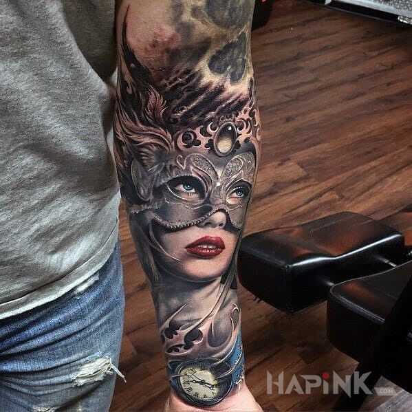Tattoo Karnawał in faces motif and realistic style on the forearm