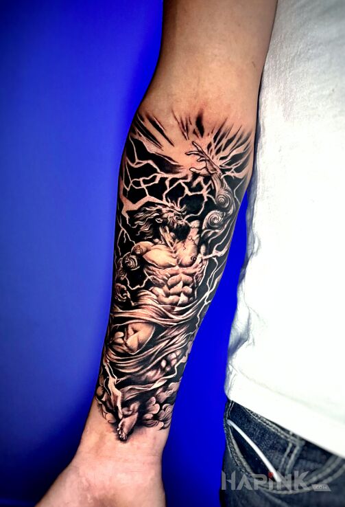 Tattoo Grecki bóg na przedramieniu in black and gray motif and graphic / illustrative style on the forearm