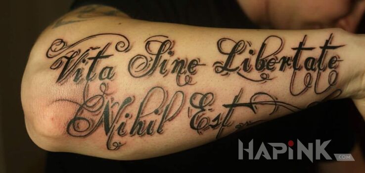 Tattoo Życie bez wolności jest niczym in lettering motif on the forearm