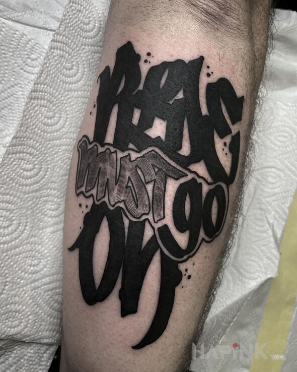 Tattoo Ride must go on. in criminal lettering motif and graffiti style on the forearm