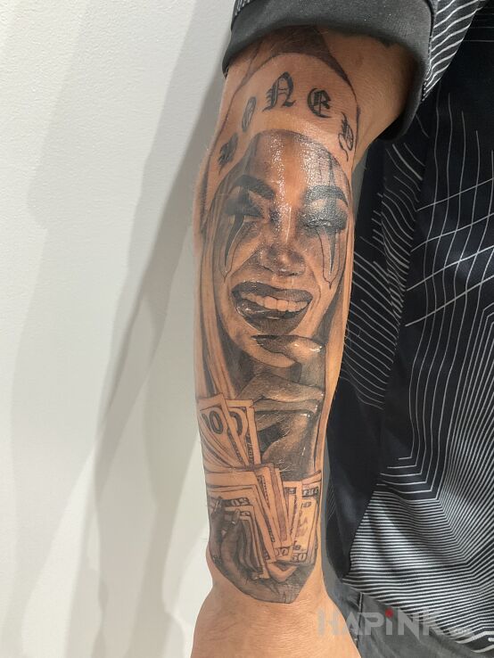 Tattoo Honey money in faces motif and realistic style on the forearm