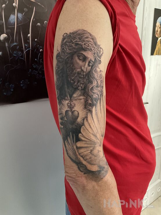Tattoo Chrystus; część rękawa in religious motif and realistic style On the arm