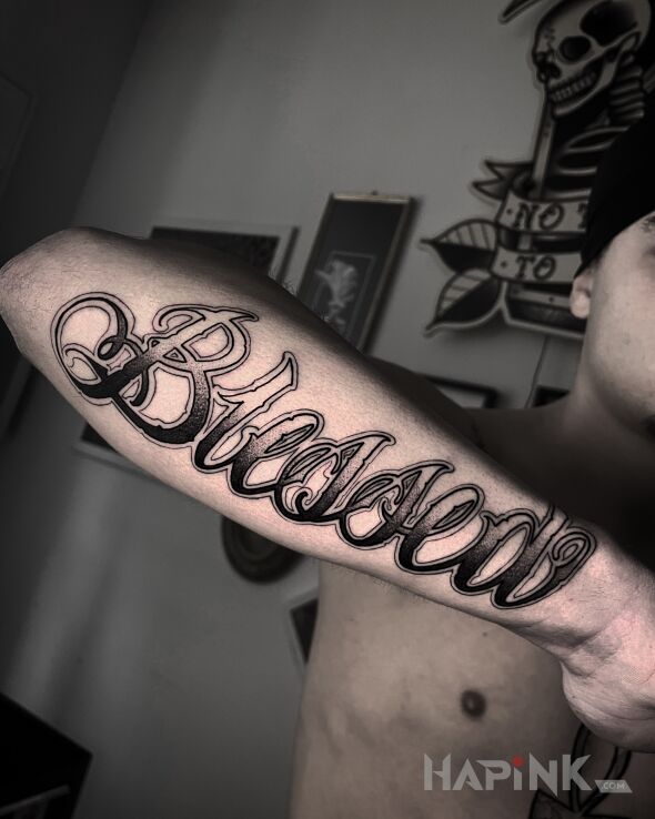 Tattoo Blessed. in black and gray motif and dotwork style On the arm