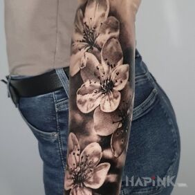 Tattoo Cherry blossoms. On the arm motif: floral style: realistic