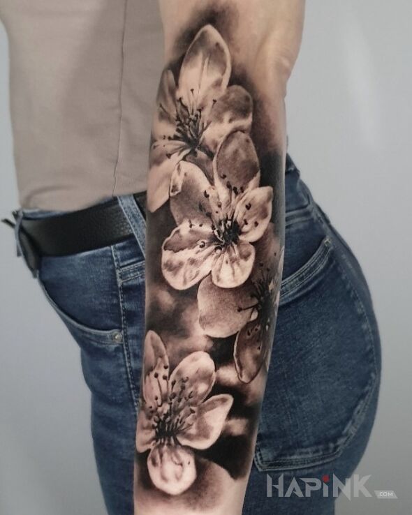 Tattoo Kwiaty wiśni. in 3D motif and realistic style on the forearm