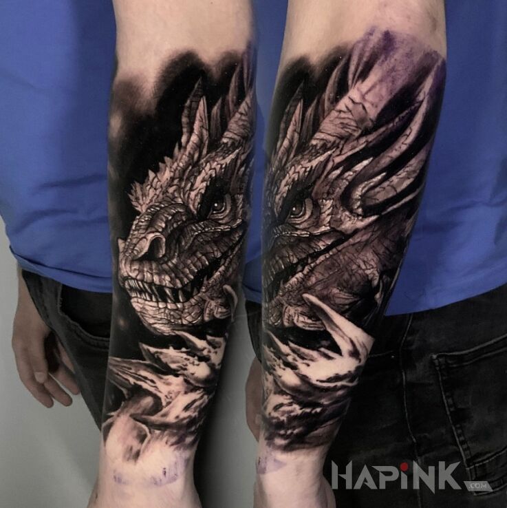 Tattoo Smaug. Smok. in dragons motif and realistic style On the arm