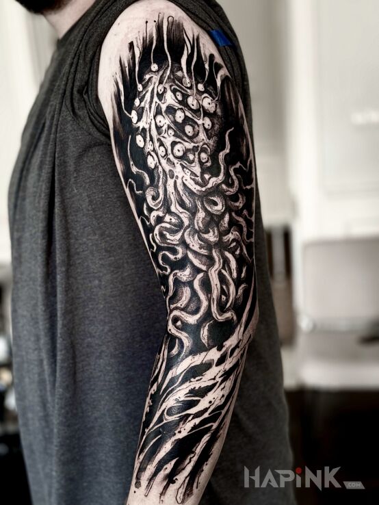 Tattoo Mackowy rękaw. in dark motif and blackwork / blackout style on the upper arm