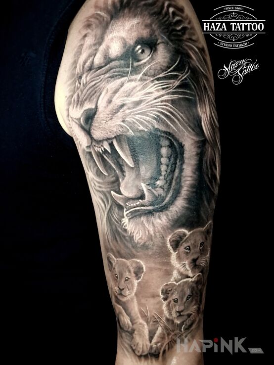 Tattoo Lion family in black and gray motif and realistic style On the arm