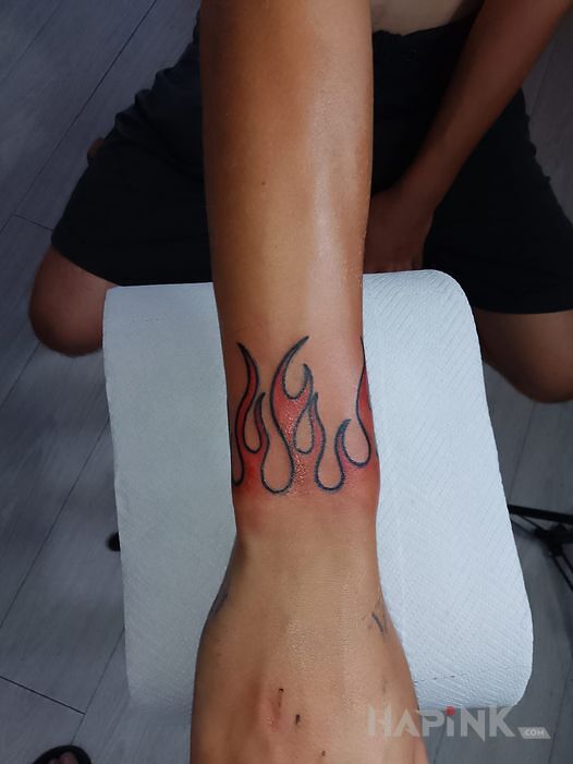Tattoo Firee in other motif and oldschool style On the arm