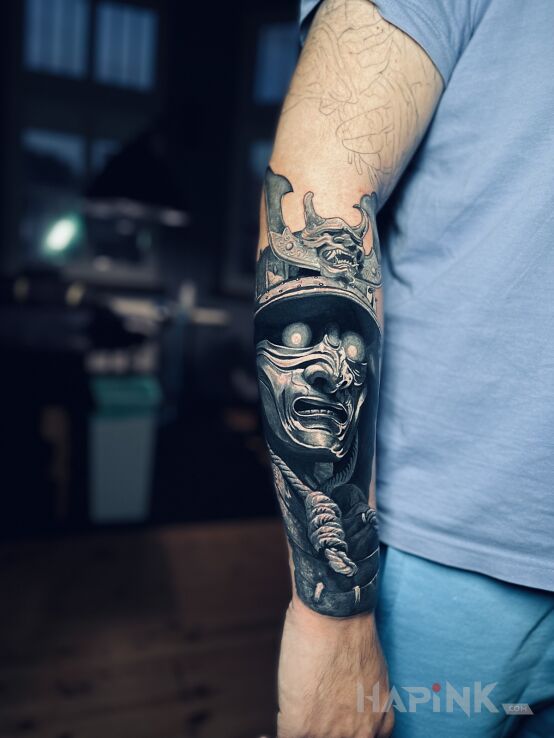 Tattoo Samuraj in characters motif and realistic style On the arm