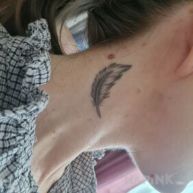 Tattoo Feather on the neck motif: black and gray style: realistic