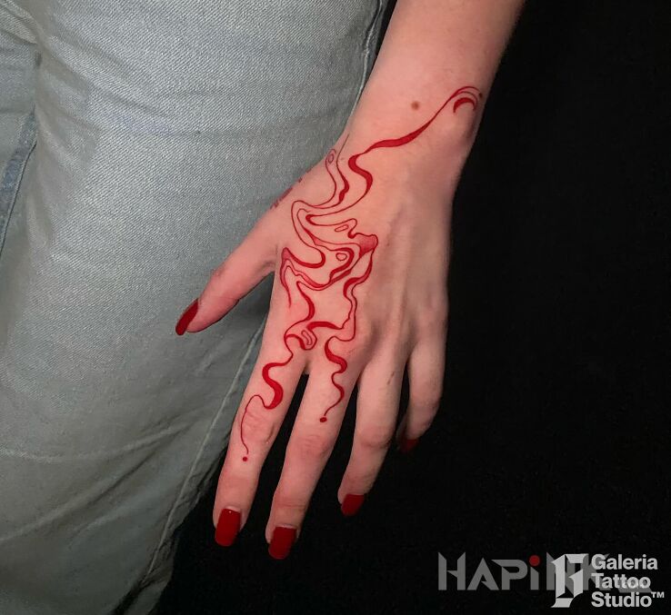 Tattoo Czerwona abstrakcja na dłoni in ornaments motif and abstract style On the arm